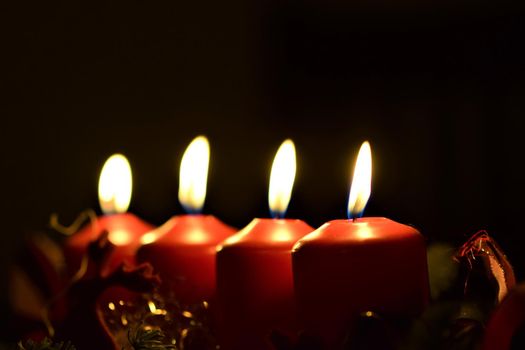 close-up of an Advent arrangement with 4 burning candles