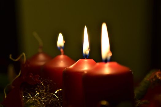 close-up of an Advent arrangement with 3 burning candles