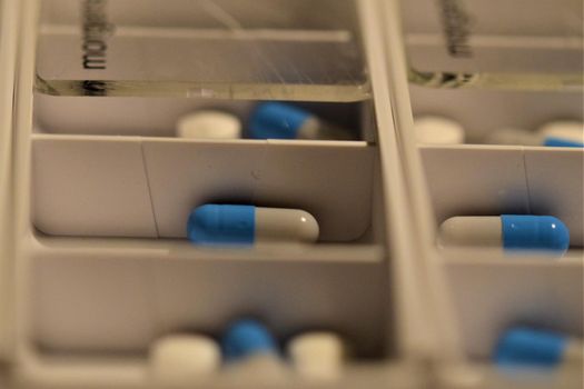Close-up of different pills prepared in tablets boxes