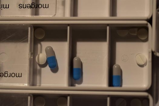 Close-up of different pills prepared in tablets boxes
