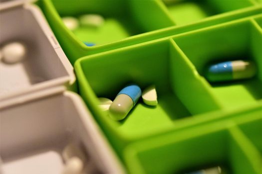 Close-up of different pills prepared in tablets boxes