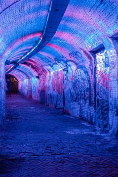  Utrecht Netherlands January 2021, colorful green, blue, pink illuminated Ganzemarkt tunnel in the center of Utrecht, The Netherlands
