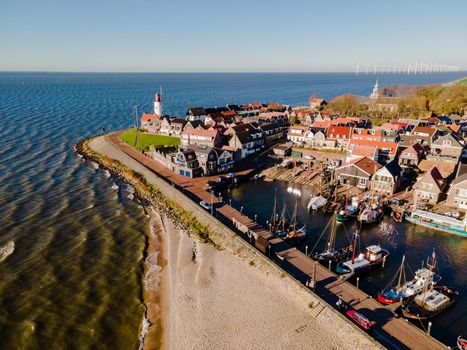 Urk lighthouse with old harbor during sunset, Urk is a small village by the lake Ijsselmeer in the Netherlands Flevoland area. beach and harbor of Urk