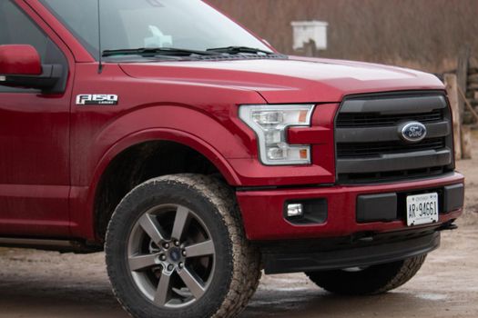 Leamington Canada, January 05 2021: Editorial photograph of a ford F150 with large winter tires that are all muddy from off road driving. Ford f150 is popular truck. High quality photo