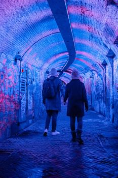  Utrecht Netherlands January 2021, colorful green, blue, pink illuminated Ganzemarkt tunnel in the center of Utrecht, The Netherlands