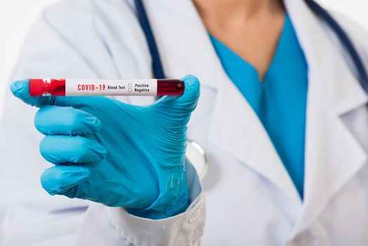 Doctor scientist in white uniform wear a mask holding test tube Coronavirus test blood sample in a clinical laboratory for analyzing isolated on white, medicine COVID-19 pandemic outbreak concept