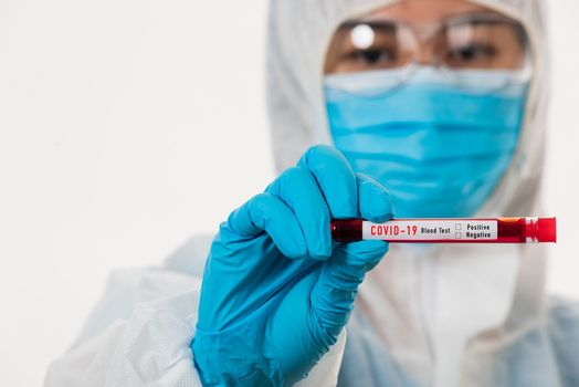 Medical scientist in PPE uniform wear a mask holding test tube Coronavirus test blood sample in a hospital laboratory for analyzing isolated on white, medicine COVID-19 pandemic outbreak concept