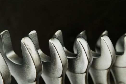 Set of spanners or wrenches in close up over a grunge stone background with free copy space