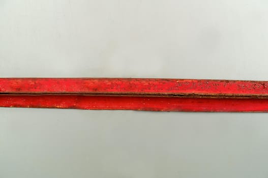 Metal rusty plate aged by time is red on a light background.Texture or background