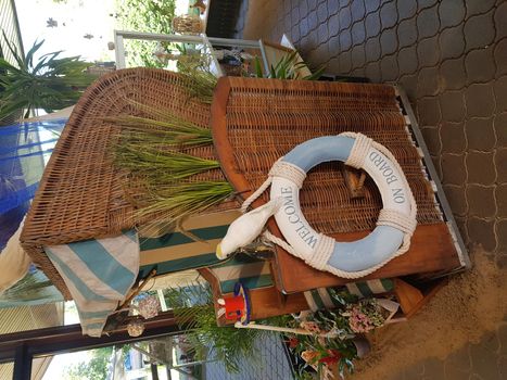 Wicker beach chair with lifebuoy - concept holiday and sea rescue