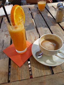 Breakfast coffee with orange juice on a wooden table