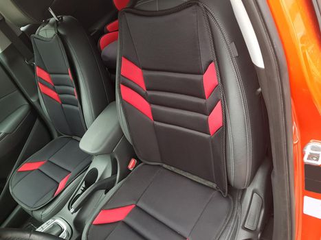 Close up, car interior. Passenger seats in modern luxury SUV car with leather seats and child seat.