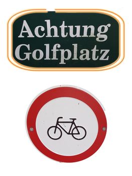 Red prohibition sign for bicycles prohibited with inscription in German Caution golf course