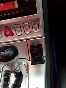 A look inside the interior of a sports car photographed on a public street.