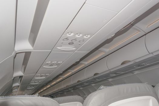The ceiling interior of an airplane with luggage space. noise