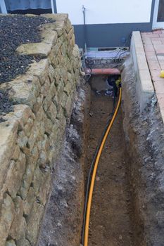 Supply lines in the ditch for the energy supply of a multiple dwelling