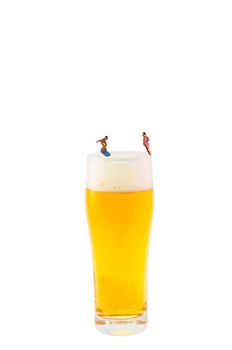 Miniature photography, miniature figures with beer glass.
Modeling figures jumping into beer glass, concept refreshment