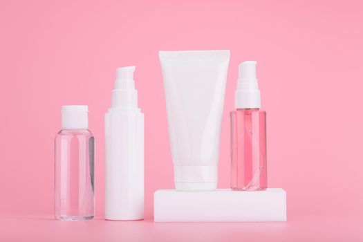 Set of skincare cosmetics against bright pink background. Concept of daily skincare routine or anti aging treatment. High quality photo