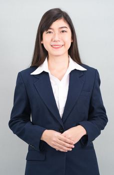 Portrait of asian business woman standing isolated on gray background