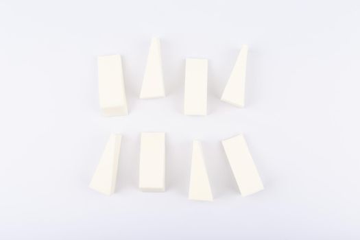 Top view of white triangle shaped make up sponges on white background. High quality photo