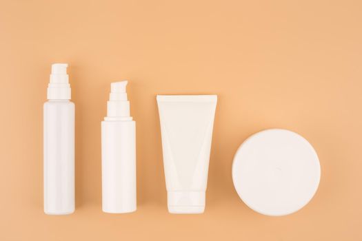 Minimalistic and simple still life with a set of cosmetic products for skin care on beige background. High quality photo