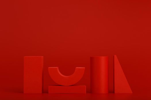 Red abstract and minimalistic still life with red geometric figures against red background with space for text. Futuristic sample, advertising or banner concept