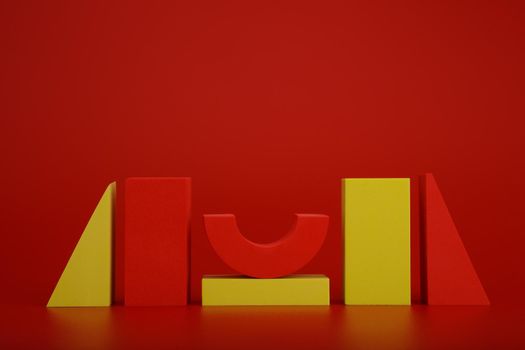 Abstract duotone still life with red and yellow geometric figures on red background with copy space. Sample for banner or advertising