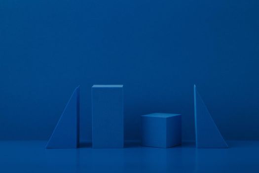 Monochromatic abstract futuristic still life with blue geometric figures on blue background with a space for text. High quality photo