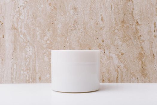 Close up of white unbranded cream jar on marble background with space for text . Concept of beauty and skin care in minimalistic style. 