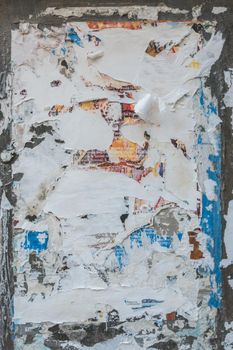 Old grunge background ripped. Vintage. Wall with multicolor paper torn.