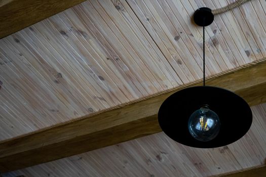 Black lamp in vintage style. Stylish lamp in an ancient wooden interior