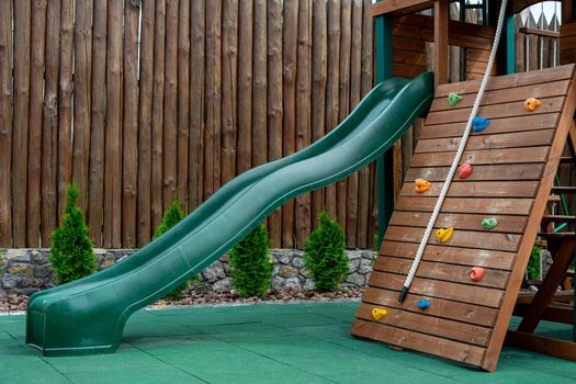 Modern children's slide is made of plastic and wood