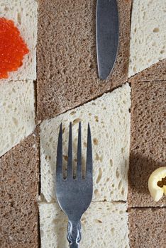 white bread and red caviar on the fork.