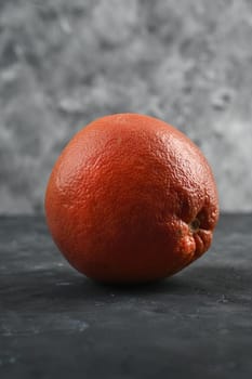 Grapefruits on a grey table and grey background.