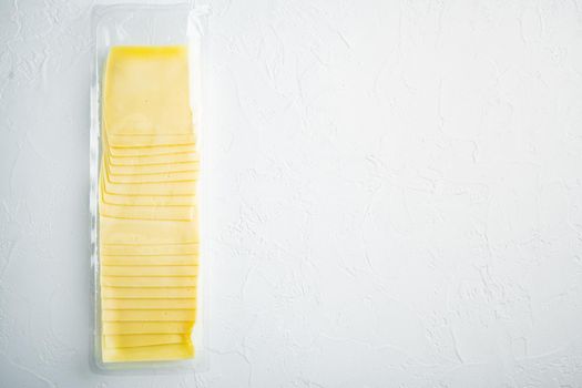 Slices of yellow cheese, sealed pack, on white background with copy space for text
