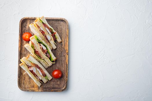 Club sandwich panini with ham, fresh tomato, cheese, on white background, top view with copy space for text