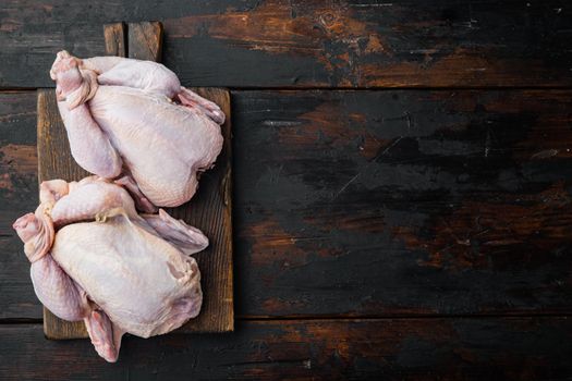 Raw organic uncooked whole chicken meat, on old wooden table, top view with copy space for text