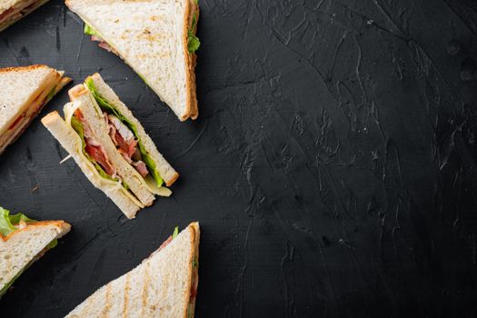 Homemade turkey club sandwich, on black background, top view with copy space for text