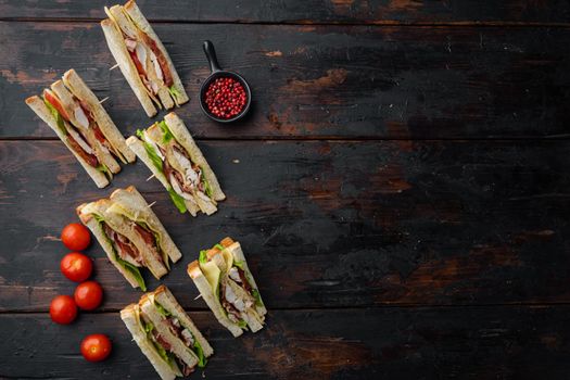 Classic club sandwich with meat, on old wooden table, top view with copy space for text
