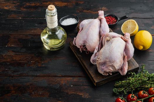 Raw organic uncooked whole chicken meat with ingredients, on old wooden table with copy space for text