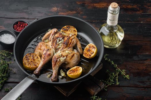 Spatchcocked chicken and herbs, on old wooden table