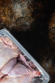 Whole raw chicken meat package, on old rustic background, top view with copy space for text