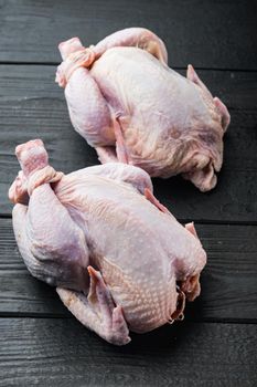 Whole raw free range fresh chicken, on black wooden background