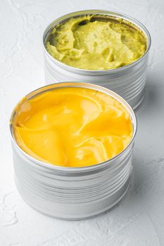 Canned guacamole and cheese dip in can, on white background
