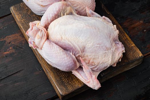 Raw small young whole chicken, on old wooden table