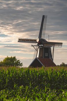 Bataaf windmill in Winterswijk in the evening sun with a cloudy sky
