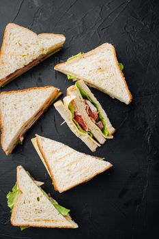 Club sandwich panini with ham, fresh tomato, cheese, on black background, top view