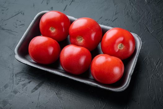 Red tomatoes, on black background