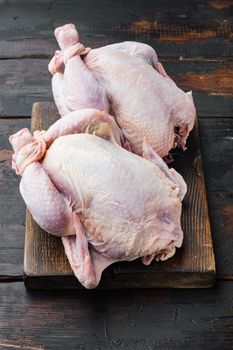 Organic whole fresh poussins, on old wooden table