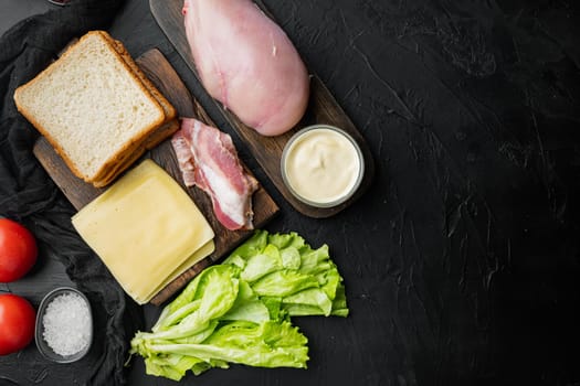 Ingredients for sandwich, bacon, cheese, tomato, chicken meat, lettuce, sauce, on black background, top view with copy space for text